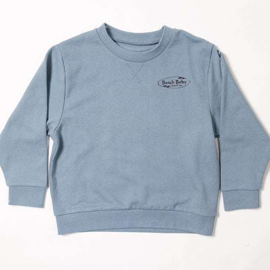 A light blue crewneck sweatshirt with a small embroidered logo on the left chest, laid flat against a white background.